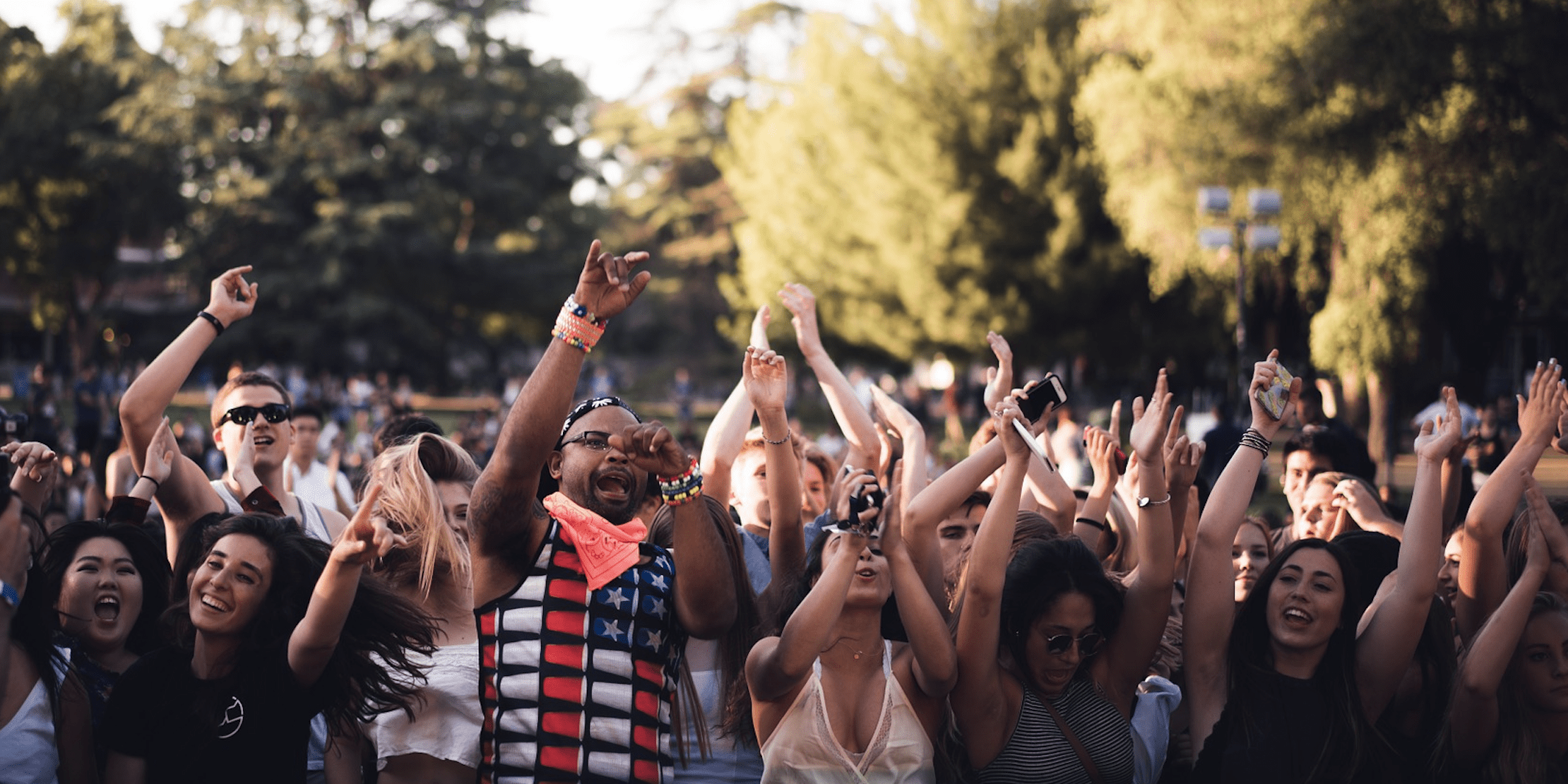 A Group of People With Raised Hands One