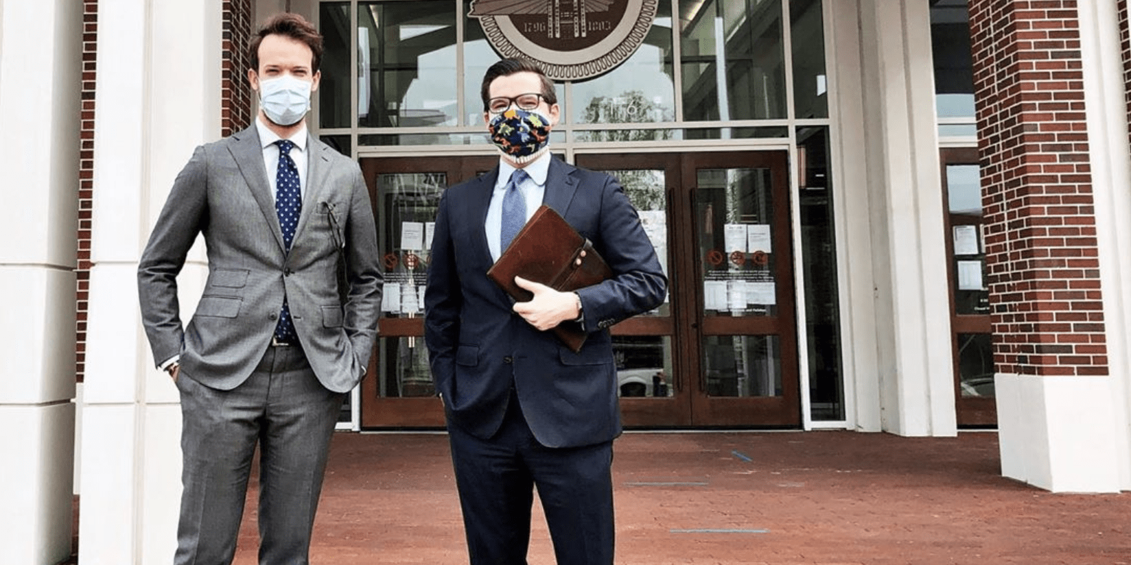 Two Men Standing Outside a Building