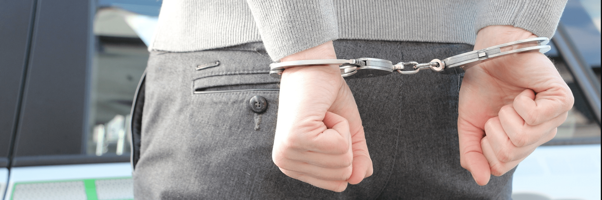 A Man in Handcuffs Behind Hand