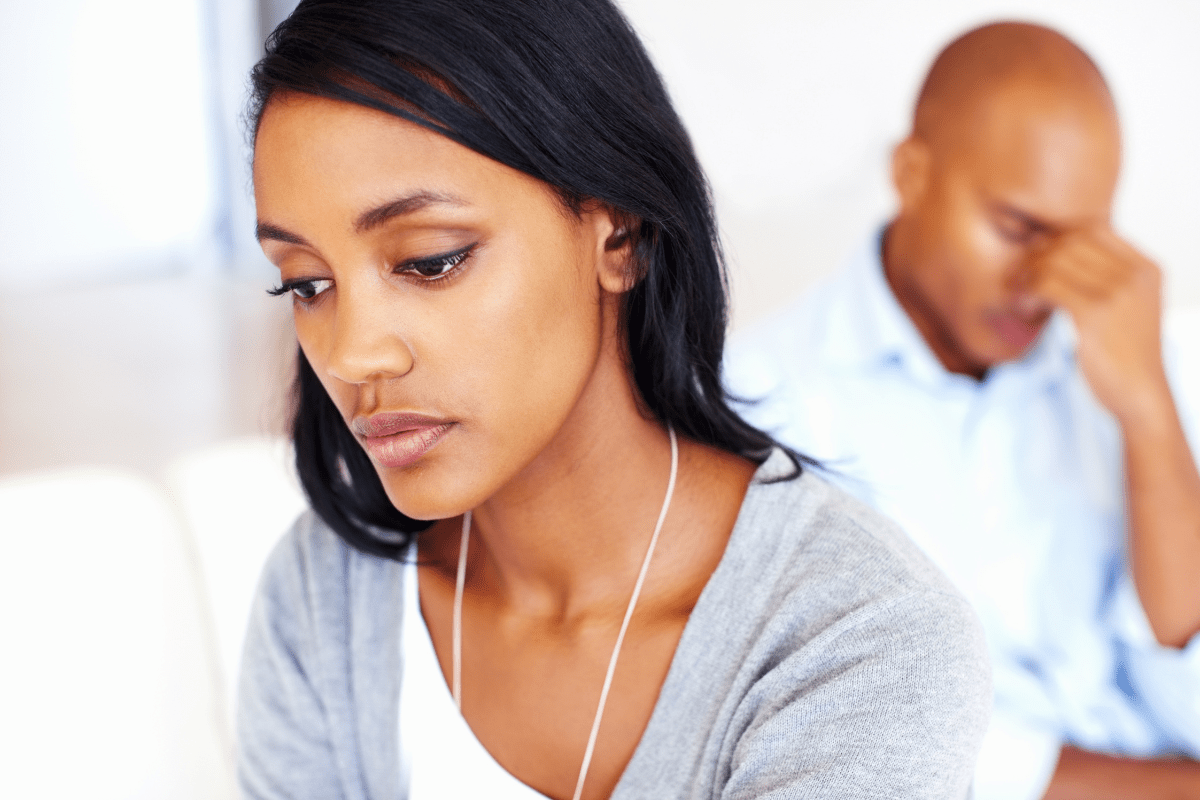 A Couple Sitting Distress in a Room